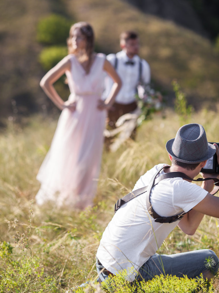 Photographer taking photos of a couple on their wedding