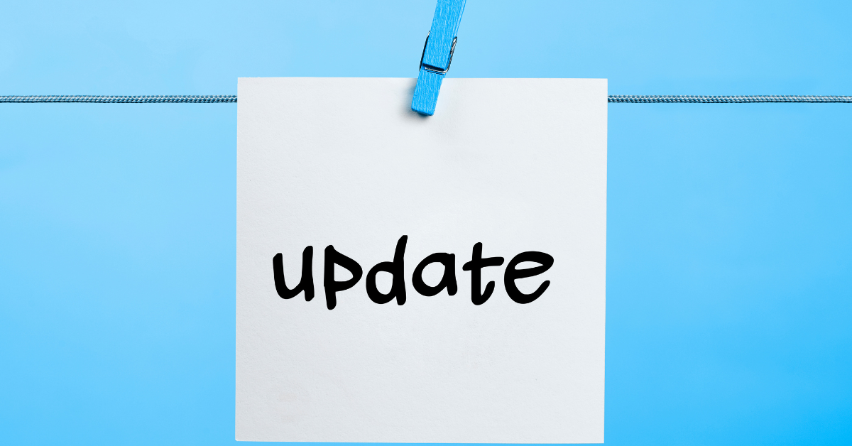 update written on a sticky note held up by a blue clip on a blue background