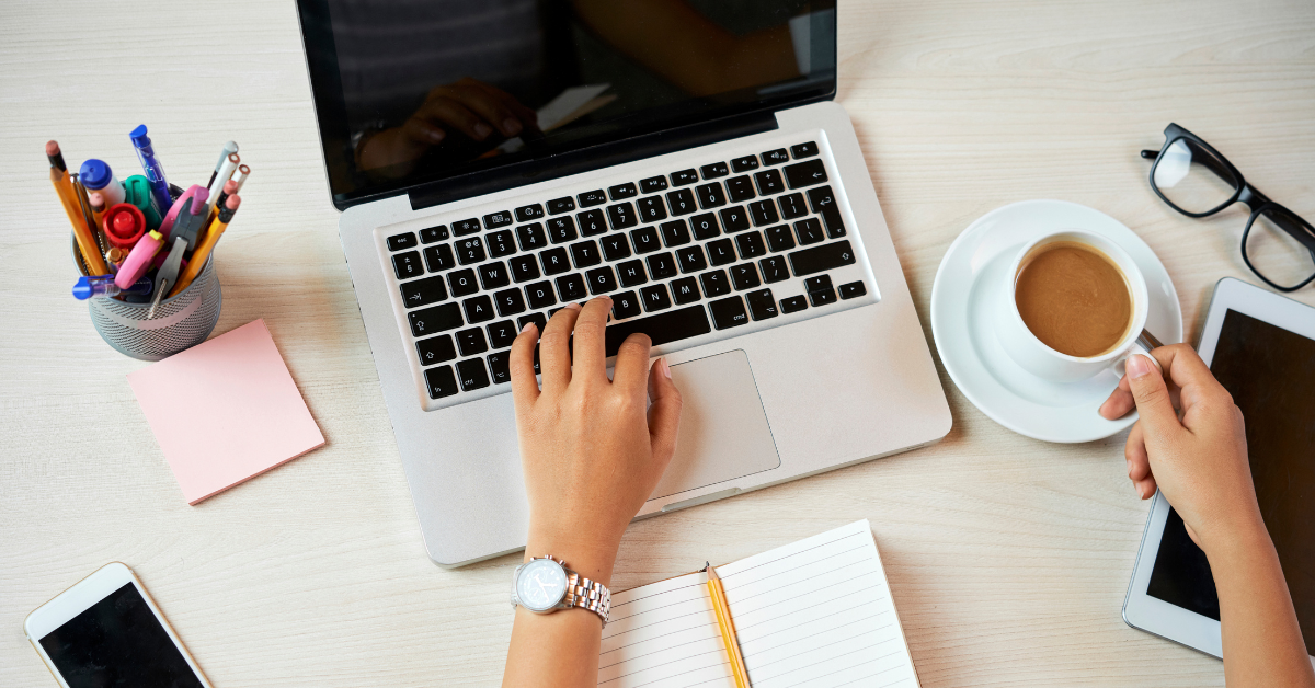 A laptop with a person typing on it.