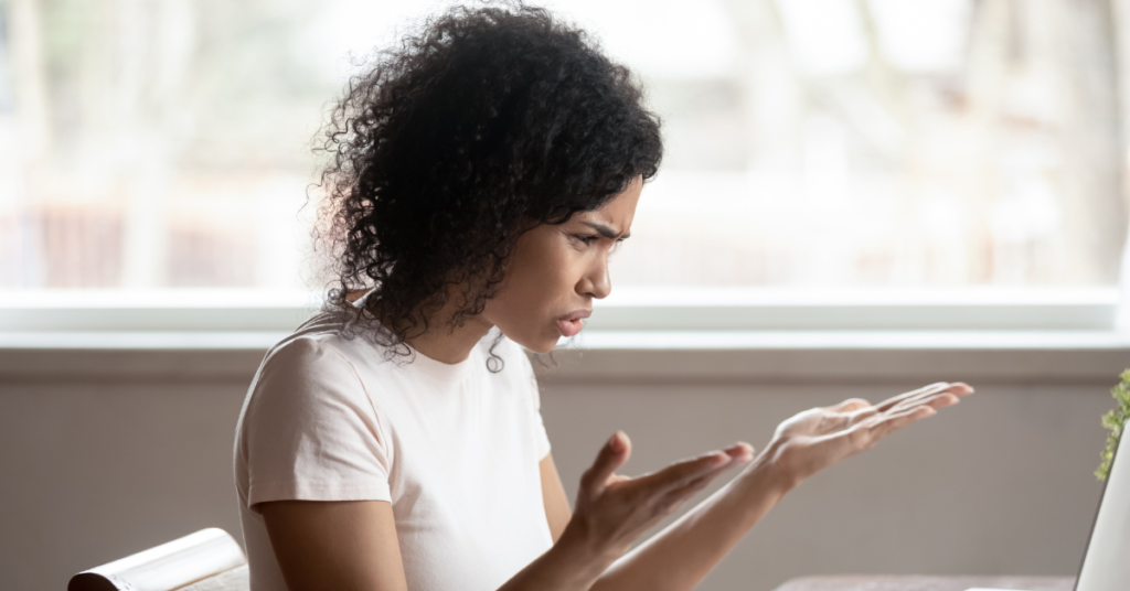 A woman looking frustrated with her computer.