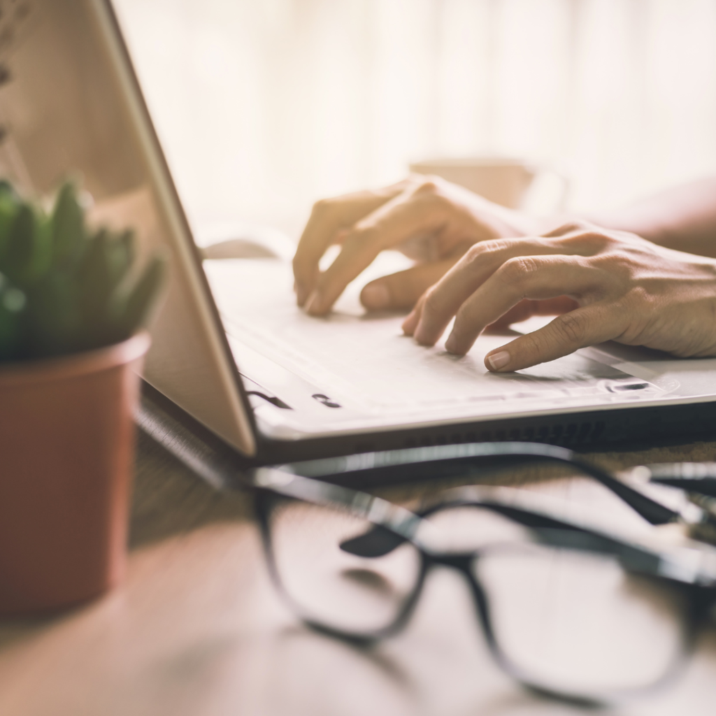 Someone typing on a laptop