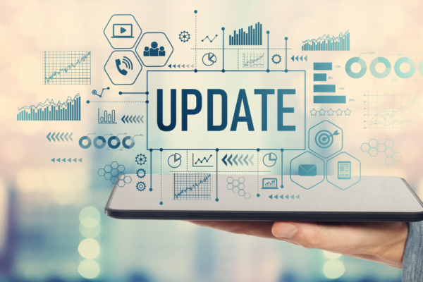 The word "update" is pictured atop a tablet surrounded by marketing icons.