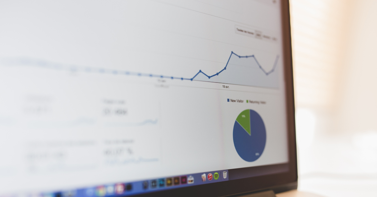 Close-up of a computer screen showing Google Analytics 4 dashboard with traffic trends and a pie chart visualization.