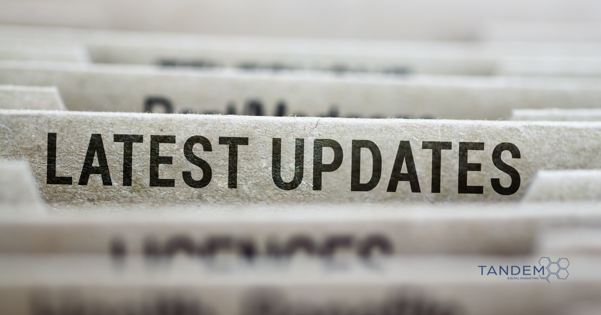 Close-up of file folder labeled "Latest Updates" with Tandem Digital Marketing logo in the corner.