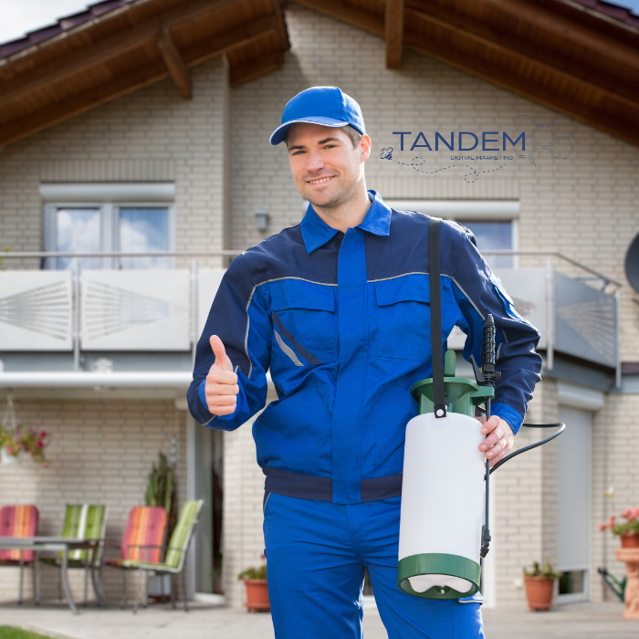 Pest Control man giving thumbs up in front of house he sprayed.