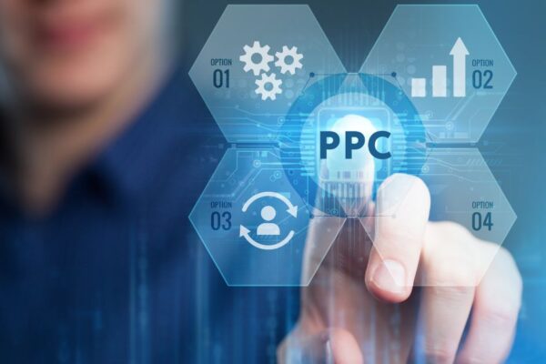 A man in a blue shirt has his finger pressed against a transparent PPC image with cogs and a person icon.