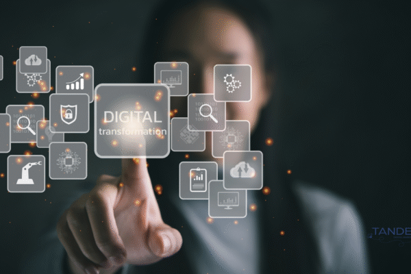 Monthly Department Update: Driving Digital Transformation at Tandem Person interacting with a digital interface featuring icons for analytics, cloud storage, automation, and the phrase "Digital Transformation"; Tandem Digital Marketing logo in the corner.