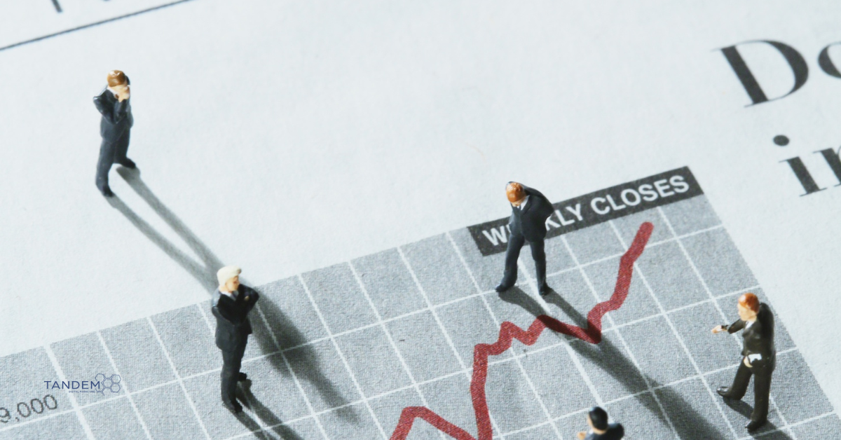 Miniature business figures standing on a financial chart labeled “Weekly Closes,” observing a rising red trend line; Tandem Digital Marketing logo in the corner.