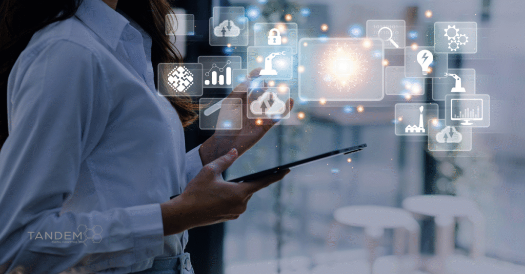 Business professional using a tablet surrounded by digital interface icons representing cloud computing, data analytics, automation, and AI; Tandem Digital Marketing logo visible.