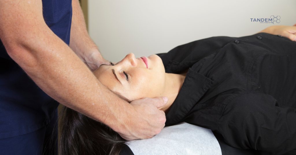 A chiropractor performing a neck adjustment on a patient, representing Tandem Interactive's specialized local SEO and digital marketing services for chiropractic practices.