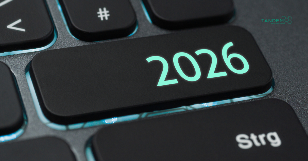 A high-quality, close-up shot of a sleek black computer keyboard with a glowing "2026" key and the Tandem Interactive logo, representing cutting-edge digital marketing trends and annual strategy updates.